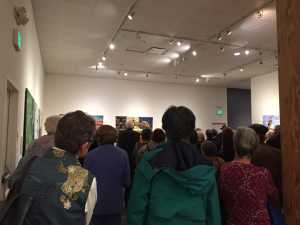 The crowd gathered for the opening of the SAQA exhibition Earth Stories at the San Jose Quilt and Textile Museum.